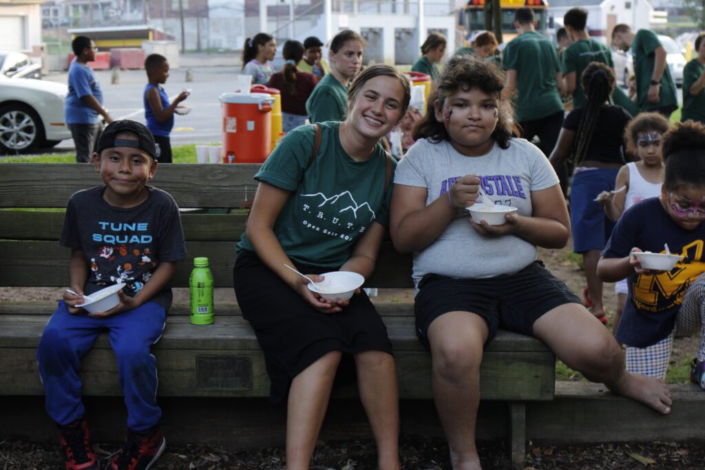 two girls smiling and eating ice cream